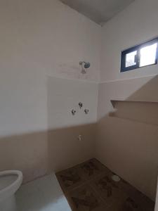 a bathroom with a toilet and a window at La Casa de la Ría in Río Lagartos +16 photos