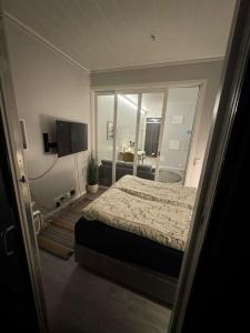 a bedroom with a bed and a large mirror at Central City Apartment in Svolvær