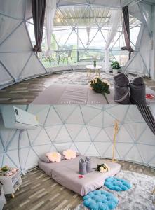 a room with a tent with pillows and flowers at เดอะซัน แกลมปิ้ง in Ban Mae Na