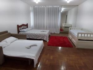 En eller flere senge i et værelse på Apartamento espaçoso e completo no Centro do Rio, perto do metro