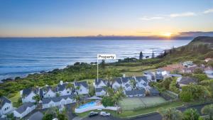 an aerial view of a resort with the ocean at Life's a Beach Pad in Lennox Head