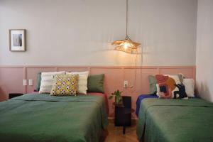 a bedroom with two beds and a pendant light at Departamento Apolo in Jamay
