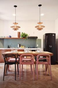 a kitchen with a wooden table and two chairs at Departamento Apolo in Jamay