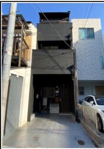 a garage in a house with a car in it at Koguma Shizuka in Osaka