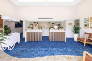 a lobby with two tables with plants on them at Club Wyndham Kirra Beach in Gold Coast +43 photos