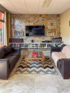 a living room with two couches and a coffee table at Pousada dos Franceses in São Paulo