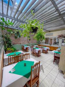 a restaurant with tables and chairs and a ceiling at Pousada dos Franceses in São Paulo