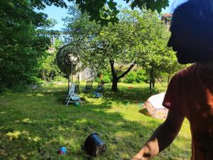 a person standing in a yard with a barrel in the grass at Apartamento Rural Casa Carolina in Brañella