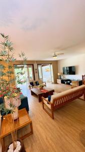 a large living room with a couch and a table at Vacation House Geribá in Búzios