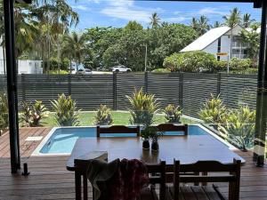 a table and chairs next to a swimming pool at Harper in Mission Beach