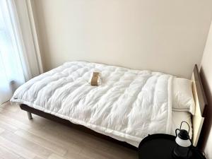 a white bed in a room with a brown bag on it at maison de Lune in Incheon +45 photos