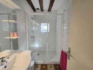 a white bathroom with a shower and a sink at Charmante maison nature avec parking et animaux acceptés - FR-1-616-459 in Pézuls