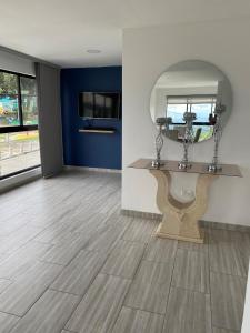 a bathroom with a sink and a mirror in a room at Apartamento en ulloa in Ulloa +25 photos