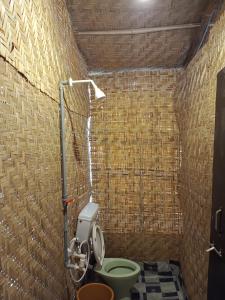 a bathroom with a toilet and a shower at Love paradice huts in Arambol