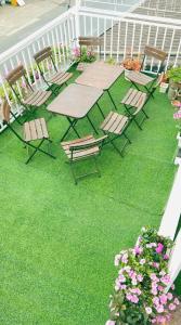 a patio with a table and chairs and some flowers at Chất home in Da Lat