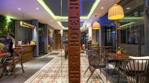 a restaurant with tables and chairs in a building at The G Hotel Hue in Hue