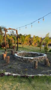 a fire pit in a park with trees and lights at The Lake Farm - Dak Lak in Buon Ma Thuot
