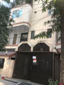 a building with a gate in front of it at Maya Eco Guest House in Dhaka