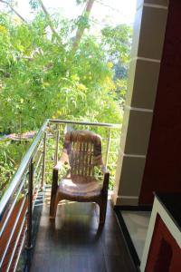 a chair sitting on top of a balcony at hope villa homestay gokarna in Gokarna