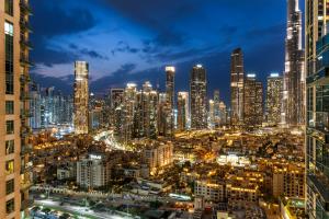 a view of a city at night at Burj Khalifa & Fountain View- 5mn walk to Dubai mall -Stylish 1BDR Apartment in Dubai