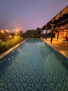 a swimming pool in a resort at night at Rao Retreat in Ấp Xuân Khai