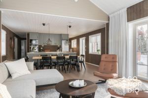 a living room with a couch and a table at The Red Fox Lodge in Tällberg