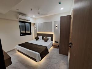 a bedroom with a large bed in a room at Hotel The 19 in Ahmedabad