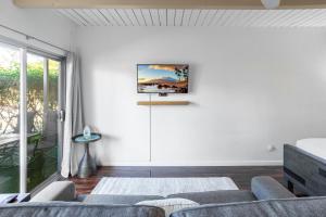 Un televizor și/sau centru de divertisment la Walk to Beach! Full Kitchen and Pool