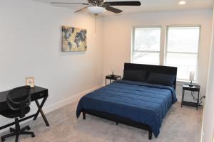 a bedroom with a bed and a desk and a piano at 4-Bed Home, Prime Houston Location in Houston