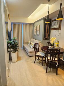 a living room with a couch and a table at Steff's Condo 1708 one bedroom at Centrio Tower in Cagayan de Oro