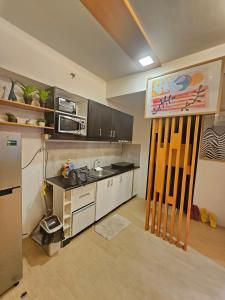 a kitchen with a sink and a counter top at Steff's Condo 1708 one bedroom at Centrio Tower in Cagayan de Oro