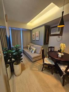 a living room with a couch and a table at Steff's Condo 1708 one bedroom at Centrio Tower in Cagayan de Oro