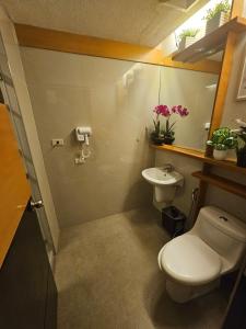 a bathroom with a toilet and a sink at Steff's Condo 1708 one bedroom at Centrio Tower in Cagayan de Oro