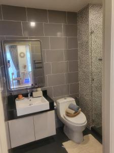 a bathroom with a toilet and a sink and a mirror at Lovely apartment in Lamai near the beach in Lamai