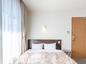 Postel nebo postele na pokoji v ubytování Kochi Terminal Hotel