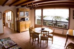 a living room with a table and chairs at Casa Rural Higeralde in Hondarribia