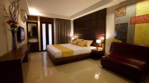 a hotel room with a bed and a couch at Collection O The Bangkok Cha Cha Suite in Bangkok