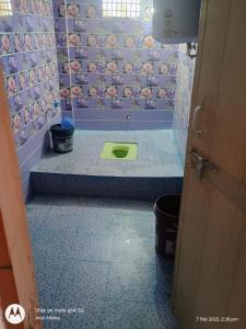 a bathroom with a shower with a green mat on the floor at Mahavir home stay in Prayagraj