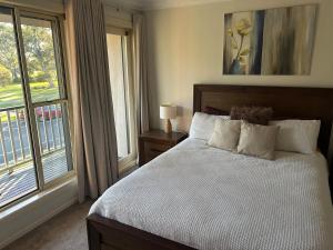 a bedroom with a bed and a large window at Cosy and convenient in Lynbrook in Lyndhurst