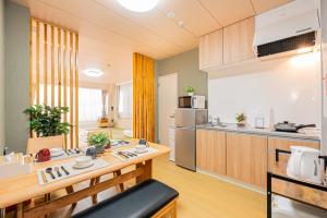 a kitchen with a table and a counter top at Mori hotel Akihabara 1 in Tokyo