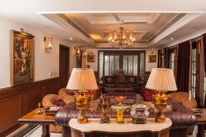 a living room with a couch and two lamps on tables at Villa 33 in New Delhi