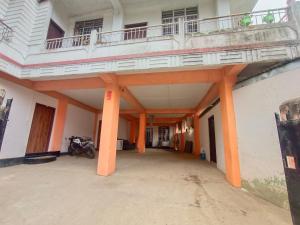 a building with a balcony on top of it at Pumpkin Lapalang Stay House in Shillong
