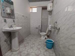 a bathroom with a sink and a toilet at Pumpkin Lapalang Stay House in Shillong +16 photos