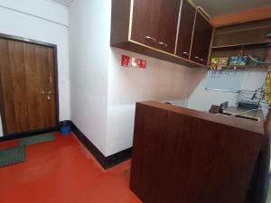 an empty kitchen with a counter and a door at Pumpkin Lapalang Stay House in Shillong