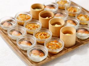 a tray filled with small plastic containers of food at Kanazawa Hakuchoro Hotel Sanraku -Natural Hot Spring- in Kanazawa