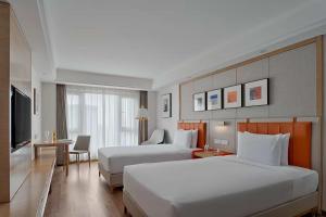 Postel nebo postele na pokoji v ubytování OneJasper Horizon Hotel
