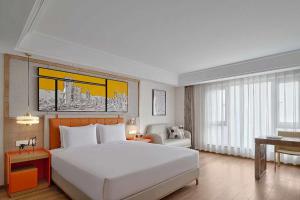 Postel nebo postele na pokoji v ubytování OneJasper Horizon Hotel