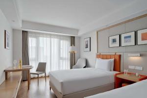 Postel nebo postele na pokoji v ubytování OneJasper Horizon Hotel