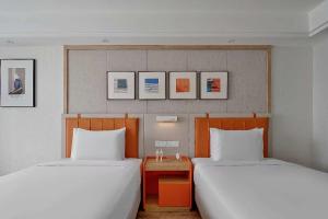 Postel nebo postele na pokoji v ubytování OneJasper Horizon Hotel