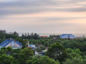 a view of a town with trees and buildings at Vườn Dừa Cam Bình 2 in Vĩnh Thạnh